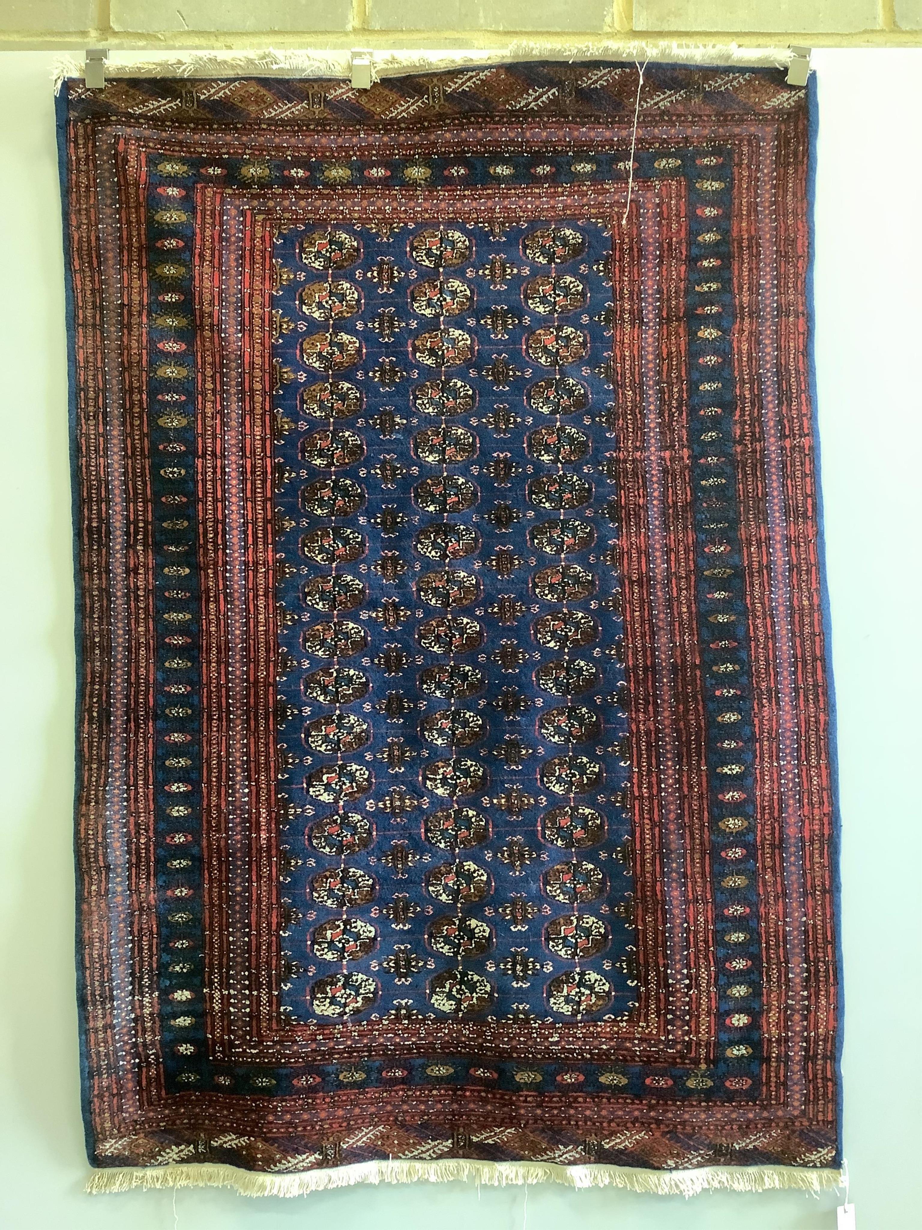 A Bokhara blue ground rug, 189 x 130cm